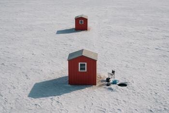 Diagram of two ice shacks in a line with a sled lane between them