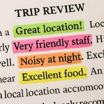 Highlighter and pen resting on marked ice fishing notes