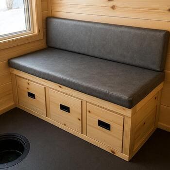 Bench in an ice shack opened to show storage compartments underneath